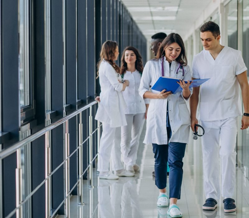 team-young-specialist-doctors-standing-corridor-hospital